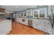 Modern white kitchen with stainless steel appliances and farmhouse sink at 9330 Bellhaven Blvd, Charlotte, NC 28214