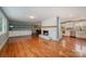 Open living area with hardwood floors, fireplace, and built-ins at 9330 Bellhaven Blvd, Charlotte, NC 28214