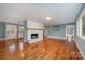 Bright living room with hardwood floors and a fireplace at 9330 Bellhaven Blvd, Charlotte, NC 28214
