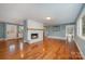 Living room with hardwood floors, fireplace and open concept at 9330 Bellhaven Blvd, Charlotte, NC 28214