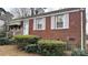 Brick ranch house with a side yard and landscaping at 1105 Norris Ave, Charlotte, NC 28206