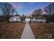 Ranch style home with white brick exterior, walkway, and landscaping at 111 Oakmont Rd, Stanley, NC 28164