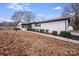 White brick ranch house with a walkway and landscaping at 111 Oakmont Rd, Stanley, NC 28164