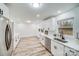 Modern kitchen with white cabinets, stainless steel appliances, and quartz countertops at 111 Oakmont Rd, Stanley, NC 28164