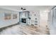 Living room with fireplace, built-in shelving, and hardwood floors at 111 Oakmont Rd, Stanley, NC 28164