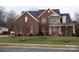 Brick two-story home with a front porch and landscaped yard at 112 Daniel Efird Dr, Mount Holly, NC 28120