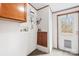 Functional laundry room with cabinets and door with pet door at 127 Mystic Ct, Troutman, NC 28166