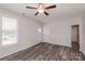 Living room with hardwood floors, neutral walls, and a view of the front yard at 13331 Central Ave, Huntersville, NC 28078