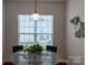 Small dining area with glass-top table and chairs near kitchen at 1489 River Bend Blvd, Fort Mill, SC 29707