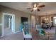 Bright living room features a view into the dining area and kitchen, along with a ceiling fan at 1489 River Bend Blvd, Fort Mill, SC 29707