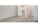 Bedroom with carpet, double door closet, and access to upper hallway at 14926 Tamarack Dr, Charlotte, NC 28278