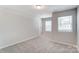 Spacious bedroom with neutral walls, carpet, and two windows at 14926 Tamarack Dr, Charlotte, NC 28278