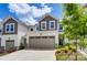 Two story townhome with taupe garage door and landscaping at 14926 Tamarack Dr, Charlotte, NC 28278