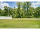 Spacious backyard with fenced-in area and wooded view at 14930 Tamarack Dr, Charlotte, NC 28278
