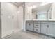 Double vanity bathroom with a large shower and modern fixtures at 14930 Tamarack Dr, Charlotte, NC 28278