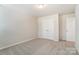 Spacious bedroom featuring a double door closet and neutral decor at 14930 Tamarack Dr, Charlotte, NC 28278