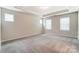 Bright bedroom with carpeted floors and tray ceiling at 14930 Tamarack Dr, Charlotte, NC 28278