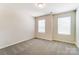 Well-lit bedroom with neutral walls and carpet flooring at 14930 Tamarack Dr, Charlotte, NC 28278
