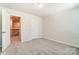Bedroom with access to upper hallway and carpeted floor at 14930 Tamarack Dr, Charlotte, NC 28278