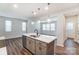 Open kitchen with island, gray cabinets, and stainless steel appliances at 14930 Tamarack Dr, Charlotte, NC 28278