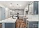 Modern kitchen with gray cabinets, quartz countertops, and island at 14930 Tamarack Dr, Charlotte, NC 28278