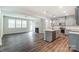 Open kitchen with island, stainless steel appliances, and gray cabinets at 14930 Tamarack Dr, Charlotte, NC 28278