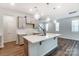 Modern kitchen with island, gray cabinets, and quartz countertops at 14930 Tamarack Dr, Charlotte, NC 28278