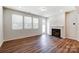 Living room with hardwood floors, fireplace, and access to backyard at 14930 Tamarack Dr, Charlotte, NC 28278