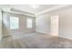 Main bedroom with carpet, tray ceiling and ensuite bathroom at 14930 Tamarack Dr, Charlotte, NC 28278