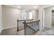 Spacious upstairs hallway with a staircase and access to bedrooms at 14930 Tamarack Dr, Charlotte, NC 28278