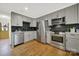 Modern kitchen with gray cabinets and stainless steel appliances at 3410 Mathis Dr, Charlotte, NC 28208