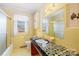 Retro bathroom with yellow walls, a tiled vanity, and a shower/tub combo at 3607 Hickory Hwy, Statesville, NC 28677