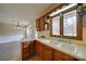 Kitchen corner sink with wood cabinets and views to backyard at 4621 Wolf Pond Rd, Monroe, NC 28112