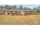 A brick house with a patio with outside furniture and well kept landscaping at 549 Dairy Rd, Troy, NC 27371