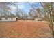 A large wooded backyard with outbuildings, offering serene and private outdoor space at 549 Dairy Rd, Troy, NC 27371