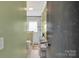 Bathroom with a shower, white tile, and fresh towels at 549 Dairy Rd, Troy, NC 27371