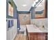 Charming bathroom with blue walls, a shower with a niche, and modern fixtures at 549 Dairy Rd, Troy, NC 27371