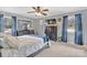 Comfortable bedroom with blue curtains, dresser, and a well-lit interior, showcasing a relaxing retreat at 549 Dairy Rd, Troy, NC 27371