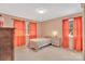 Cozy bedroom with neutral walls, orange curtains, one bed, and natural light from two windows at 549 Dairy Rd, Troy, NC 27371