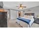 Bedroom featuring a ceiling fan, closet, queen bed with a padded headboard and neutral walls at 549 Dairy Rd, Troy, NC 27371