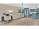 Open dining area with a view of the modern kitchen featuring blue cabinets and stainless appliances at 549 Dairy Rd, Troy, NC 27371