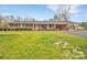 Charming brick ranch-style home with a covered front porch and well-manicured landscaping at 549 Dairy Rd, Troy, NC 27371