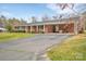 Charming brick ranch with a covered carport and well-maintained landscaping at 549 Dairy Rd, Troy, NC 27371