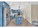Modern kitchen featuring a center island, stainless steel appliances, and stylish blue cabinets at 549 Dairy Rd, Troy, NC 27371