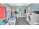 Spacious laundry room with blue walls, modern appliances, and ample storage for efficient organization at 549 Dairy Rd, Troy, NC 27371
