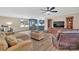 Open living room view showcasing the eat-in kitchen with blue cabinets and stainless steel appliances at 549 Dairy Rd, Troy, NC 27371
