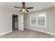 Spacious bedroom with ceiling fan and access to upper level at 571 Westside Cir, China Grove, NC 28023