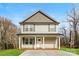 Two-story house with gray siding, a front porch, and a driveway at 571 Westside Cir, China Grove, NC 28023