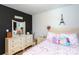 Bright bedroom featuring a white dresser and a heart patterned bedspread at 6307 Pennacook Dr, Charlotte, NC 28214