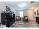 Spacious living room featuring comfy armchairs and a large TV at 6307 Pennacook Dr, Charlotte, NC 28214